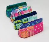 four colorful zipper pouches in a row
