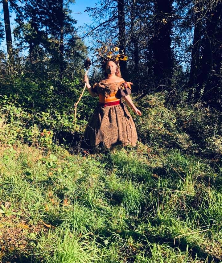 Ronya Lake wearing a hand made forest witch halloween costume, standing in the forest. 