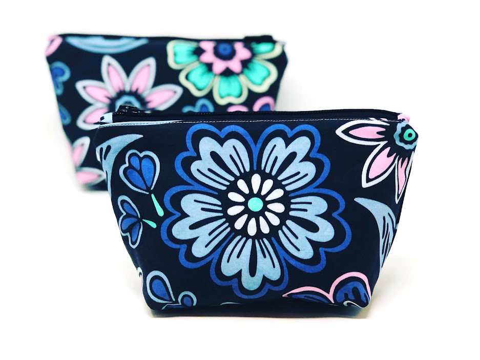 two handmade zipper pouches with a blue floral design