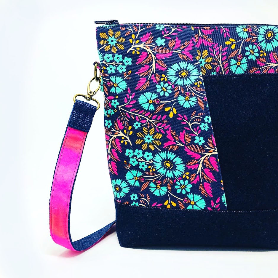a hand made purse with a floral fabric design